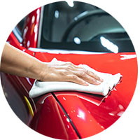 Car detailing - the holds the microfiber in hand and polishes t
